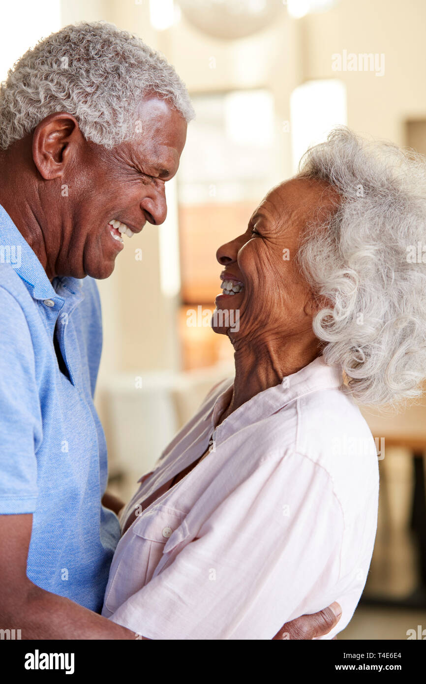 Profile Shot Loving Senior Couple Hugging At Home Together Stock Photo