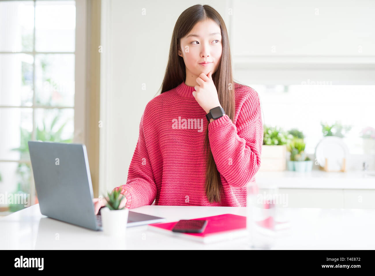 Beautiful Asian woman working using computer laptop serious face ...