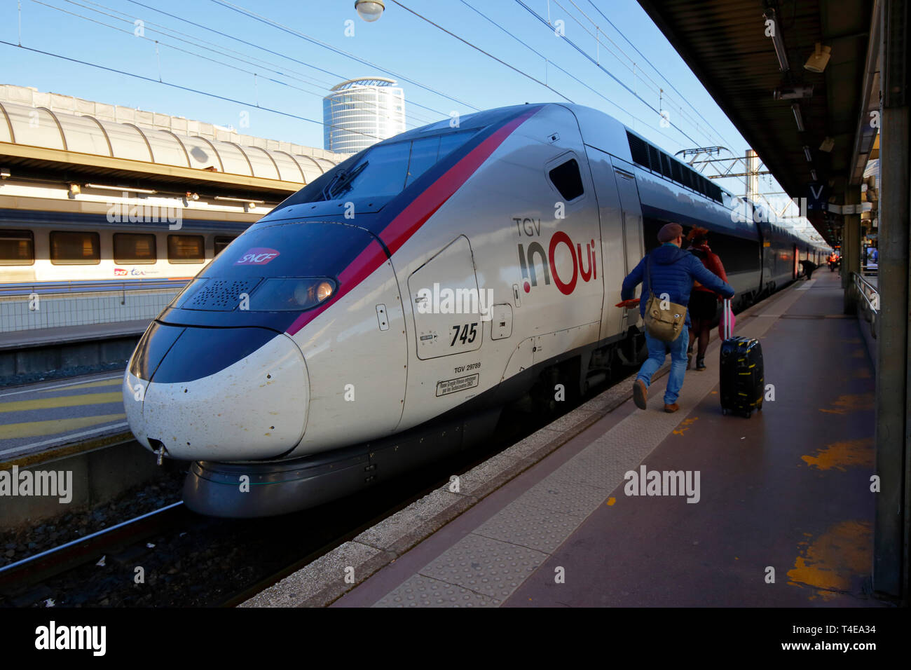 People running to catch the train, a TGV inOui high speed express train Stock Photo