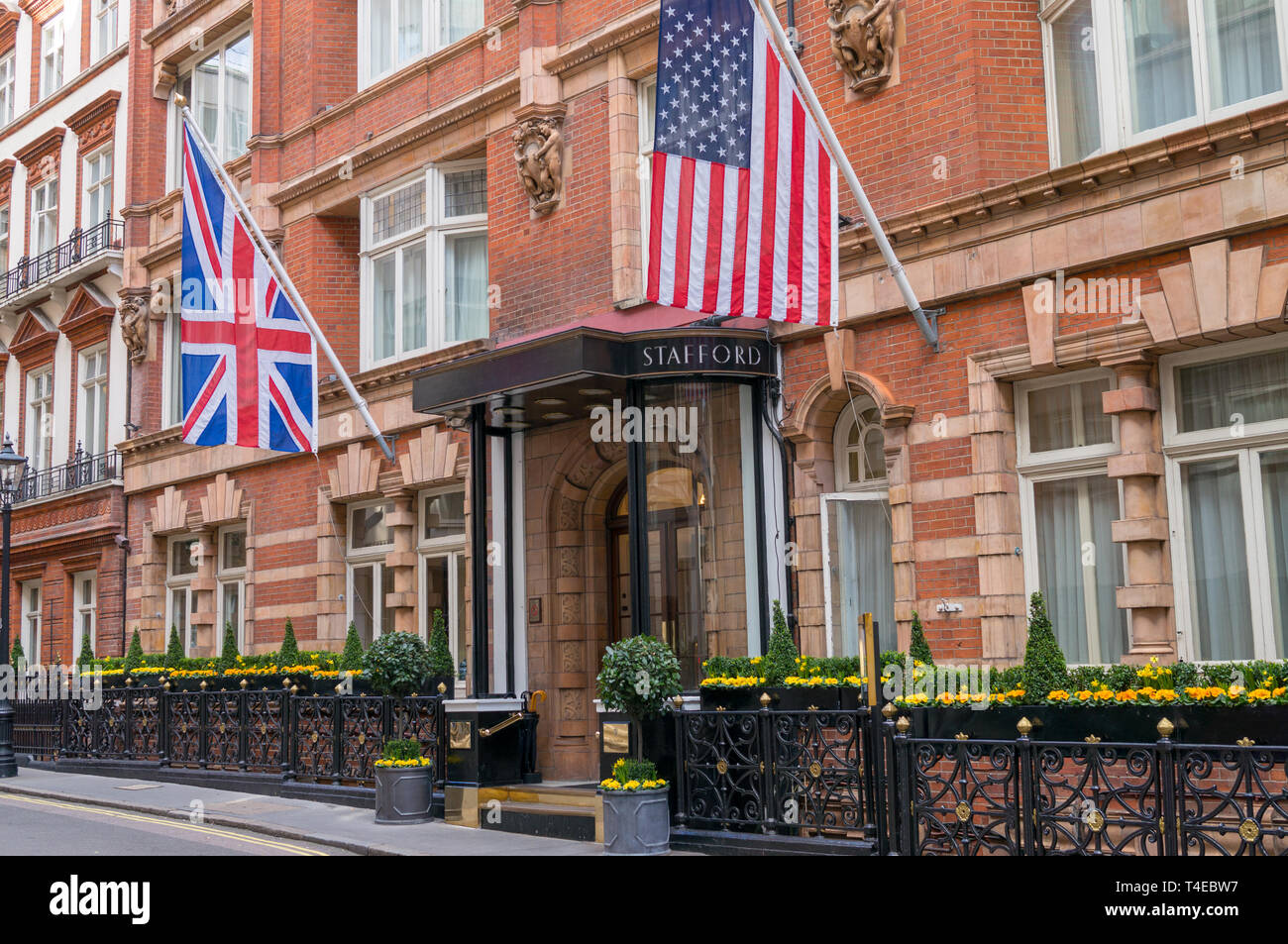 The entrance to the Stafford Hotel in London with a Union Jack (British flag) and American flag on either side. Stock Photo