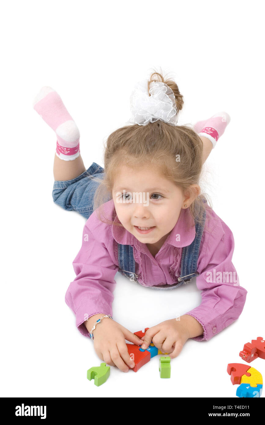 little cute girl playing with puzzles on white background Stock Photo ...