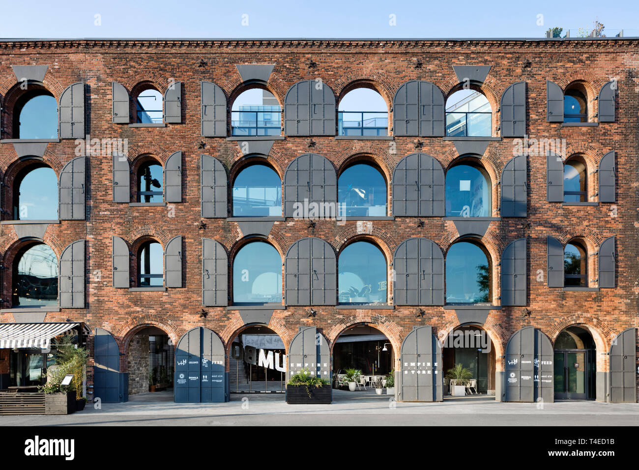 Historic warehouse facade with open arches to the courtyard of the