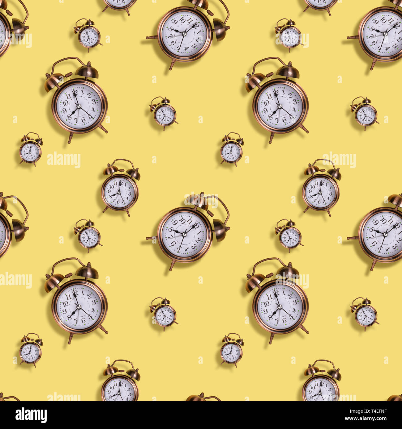 Seamless alarm clock pattern on yellow background Stock Photo - Alamy