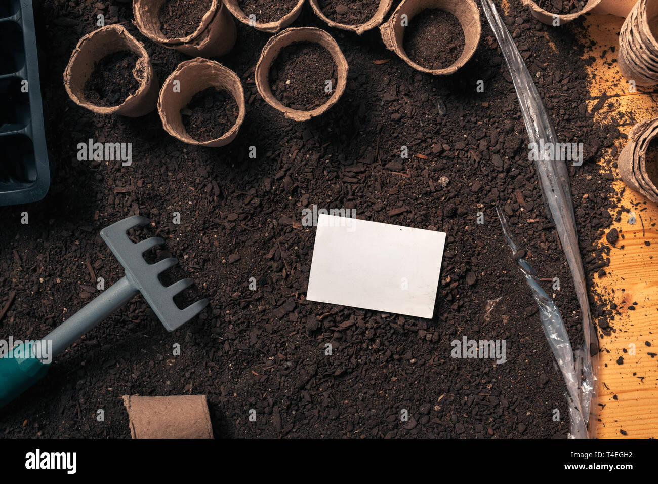 Business card mock up for organic gardening and farming activity, top view of blank card on humus soil Stock Photo
