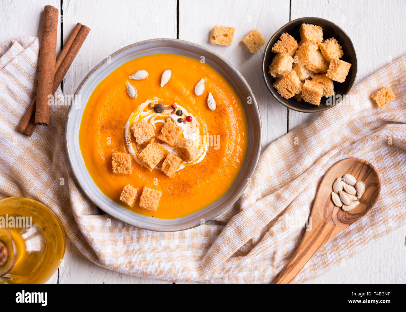 pumpkin soup with croutons on white wooden background Stock Photo - Alamy