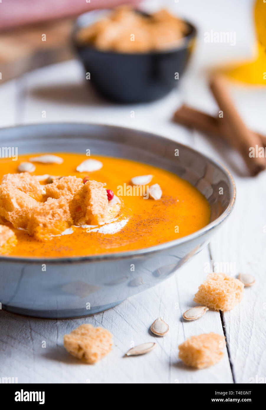 pumpkin soup with croutons on white wooden background Stock Photo - Alamy