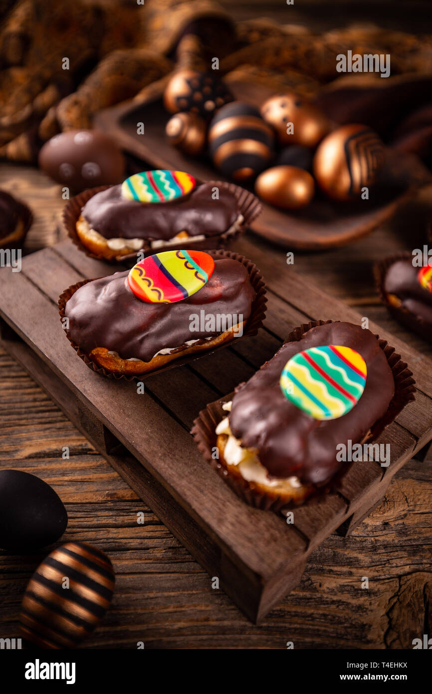 Fresh profitler eclairs with Easter decoration Stock Photo
