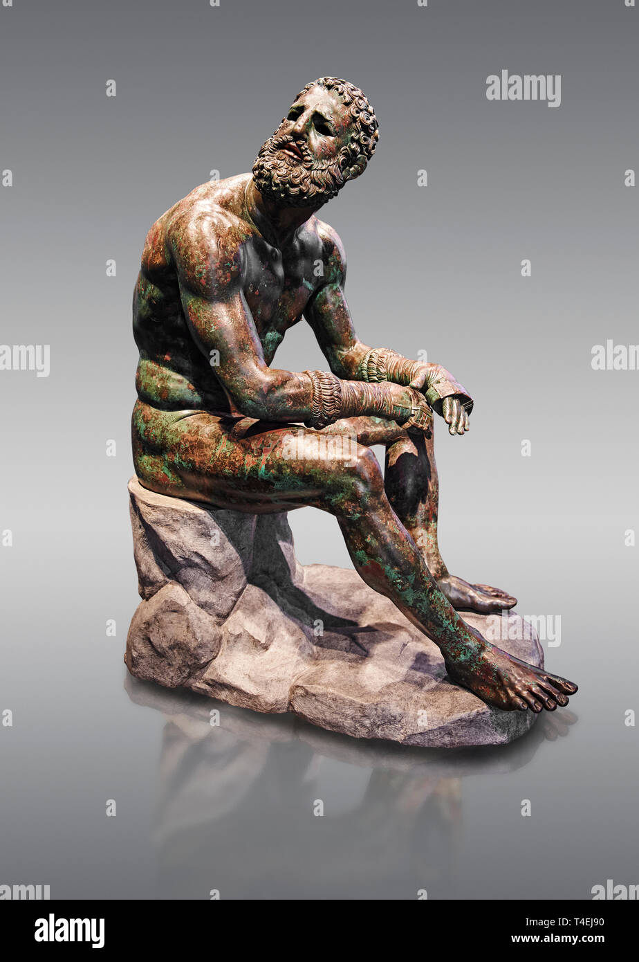 Rare original Greek bronze statue of an Athlete after a boxing match, a 1st cent BC. The athlete, seated on a boulder, is resting after a boxing match Stock Photo