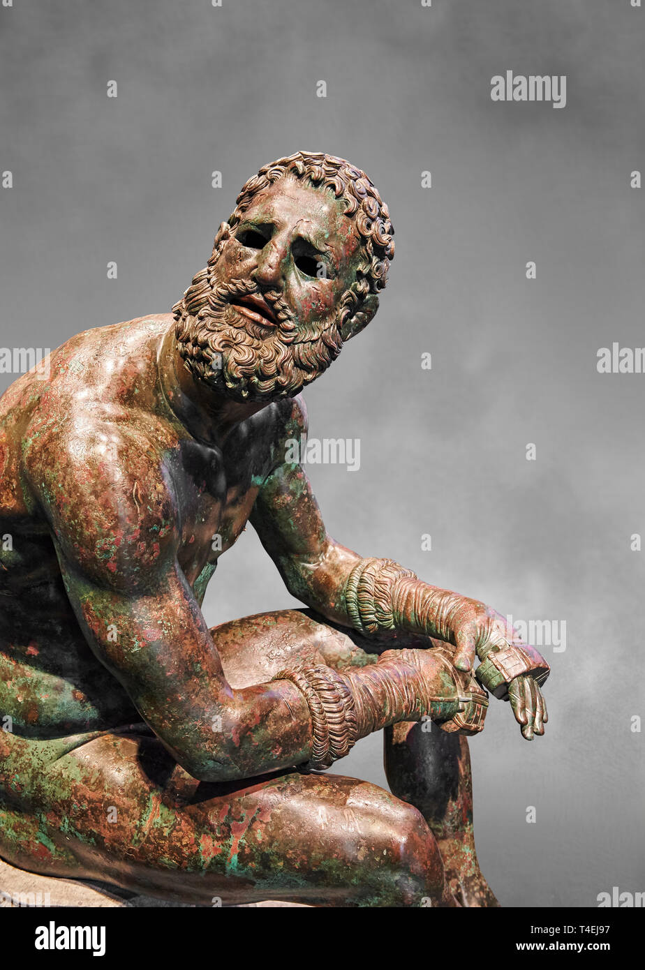 Rare original Greek bronze statue of an Athlete after a boxing match, a 1st cent BC. The athlete, seated on a boulder, is resting after a boxing match Stock Photo