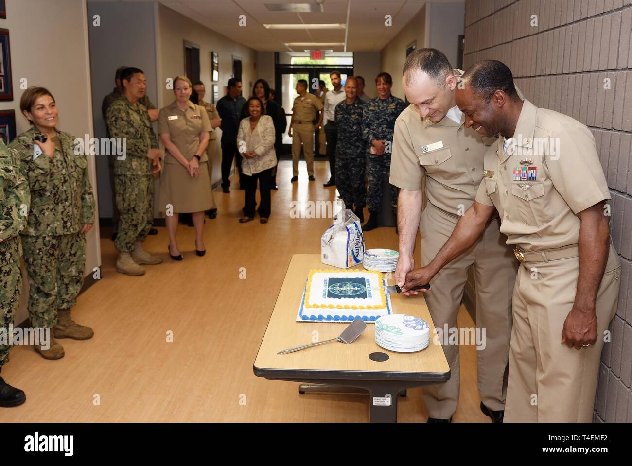 Navy Medicine West (NMW) Command Master Chief Loren Rucker and Chief Hospital Corpsman Noghayin Idele cut the birthday cake for the Chief Petty Officer’s 126th birthday during an all hands call at regional headquarters onboard Naval Base San Diego. NMW provides medical care to nearly 700,000 beneficiaries throughout the West Coast of the U.S., Asia, and the Pacific. Globally, NMW oversees eight research laboratories across the U.S. and overseas that deliver research expertise in support of warfighter health and readiness. Stock Photo
