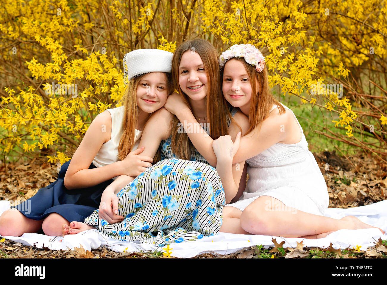 Young girls Spring portrait forsythia backdrop Stock Photo