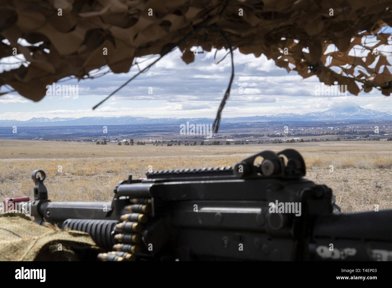 Airmen of the 823d Base Defense Squadron sit in their defensive fighting positions and keep watch during the Mission Readiness Exercise (MRX) at Camp Guernsey, Wyo., March 25, 2019. Airmen dug out the defensive fighting positions around the camp to establish perimeter security. Stock Photo