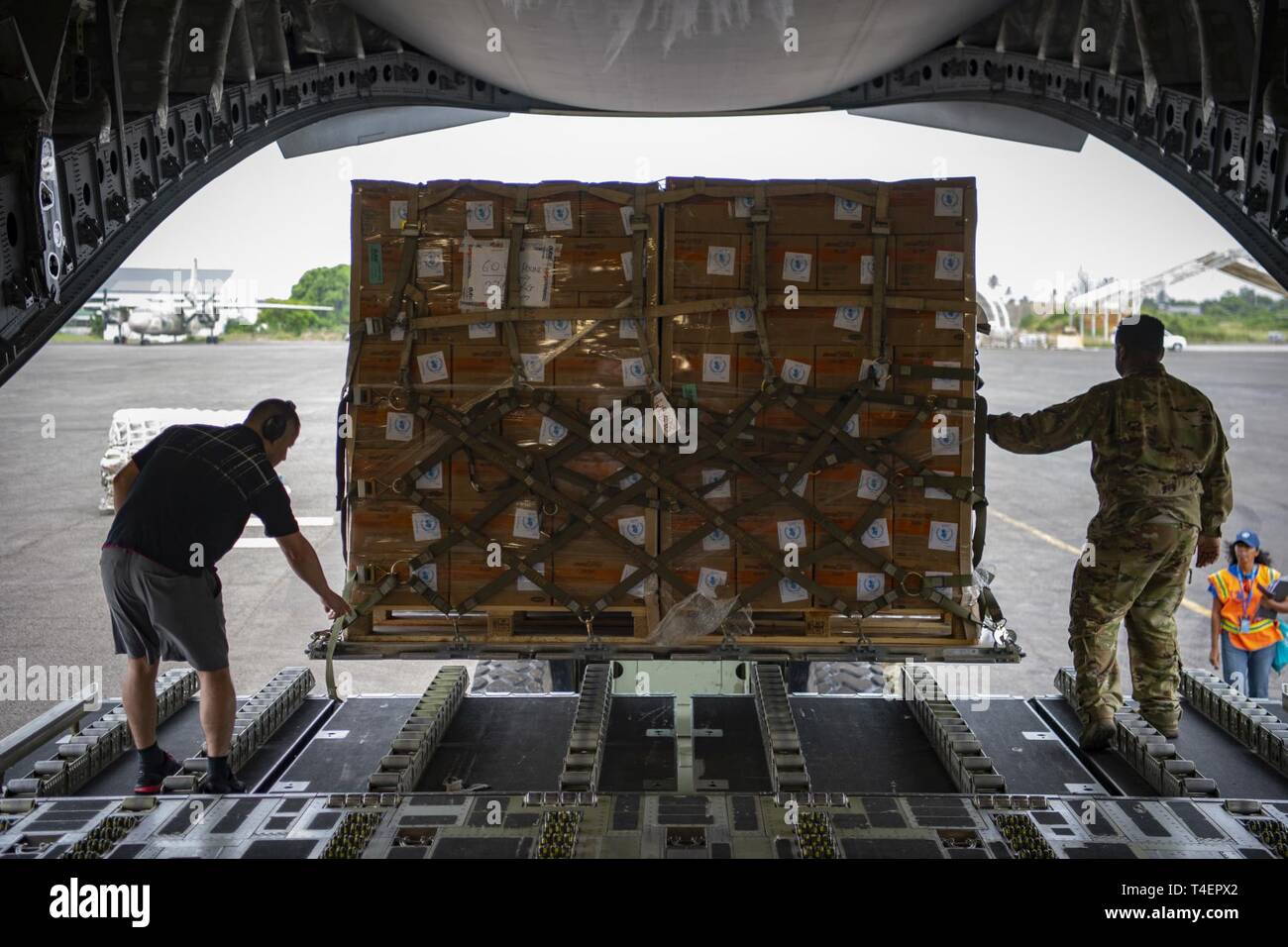 Boxes of Plumpy Sup are loaded in a C-17 Globemaster III assigned to the 16th Airlift Squadron, Joint Base Charleston, Charleston, South Carolina, supporting Combined Joint Task Force-Horn of Africa, in Maputo, Mozambique, April 2, 2019. The task force is helping meet requirements identified by the United States Agency for International Development (USAID) assessment teams and humanitarian organizations working in the region by providing logistics support and manpower to USAID at the request of the Government of the Republic of Mozambique. Stock Photo