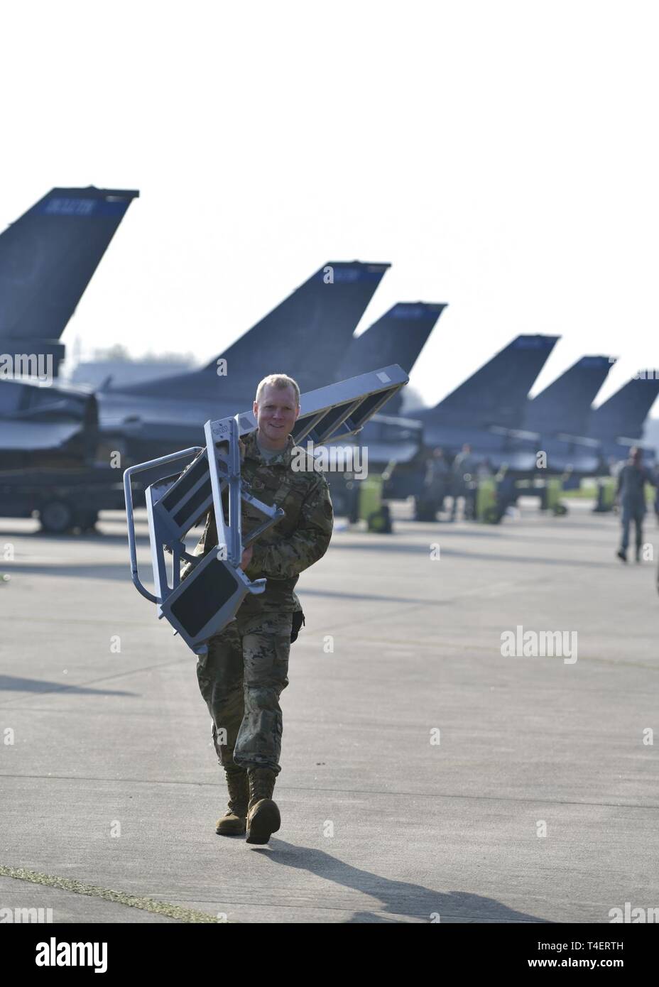 An airman from the 148th Maintenance Group from the Duluth, Minn. based 148th Fighter Wing helps complete the routine maintenance activities for F-16 Aircraft for  Frisian Flag 2019 held at Leeuwarden Air Base.  Frisian Flag is a 12-day NATO partnership exercise in the Netherlands that will allow all international participants of the exercise to execute training on operational tactics in a global setting with multiple coalition partners like Germany, Poland, France, and the United States who are participating in this year’s event. Stock Photo