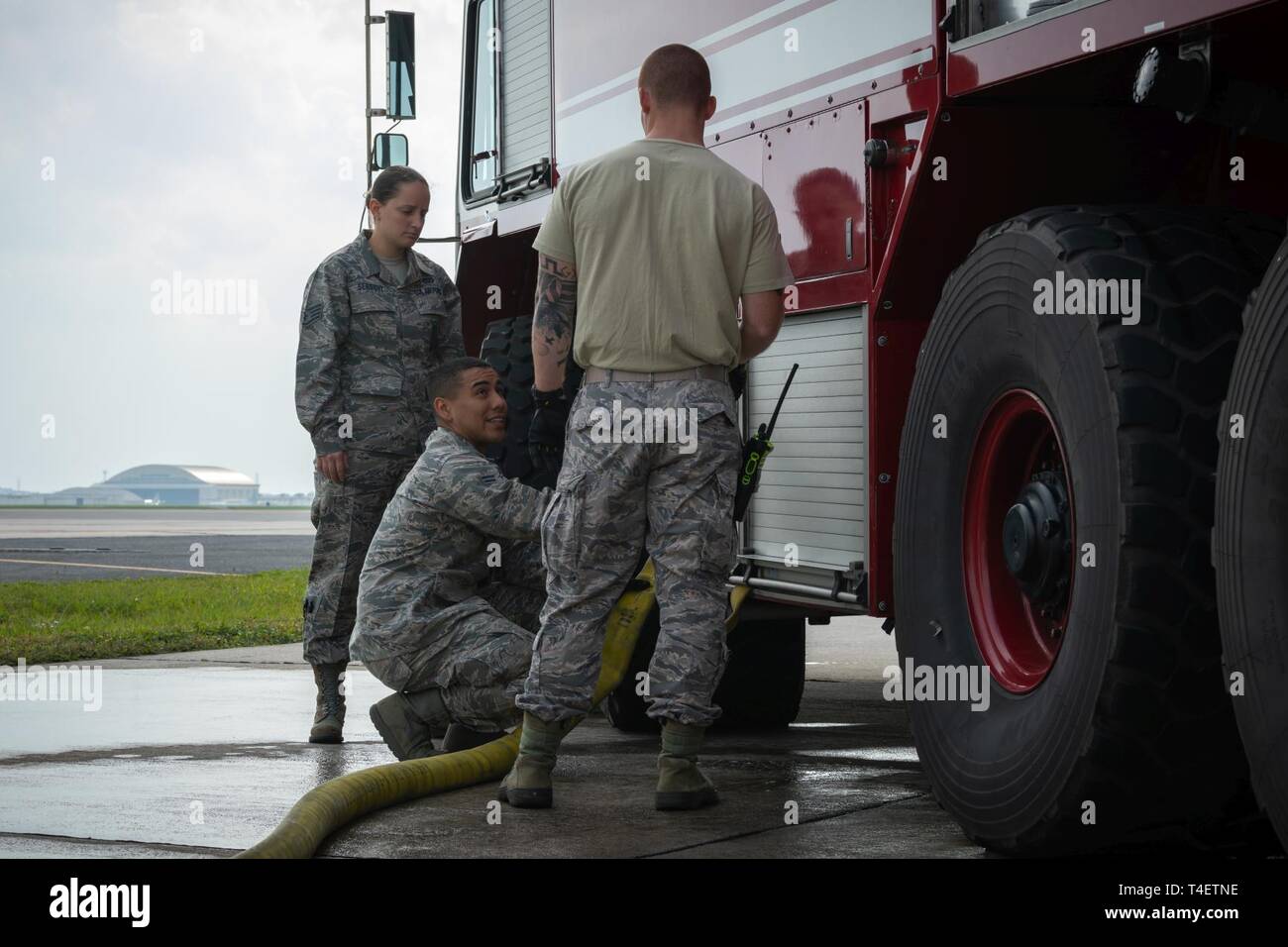 U S Air Force Airman 1st Class Kevin Guerrero 18th Civil Engineer Squadron Firefighter Pumps Water Into