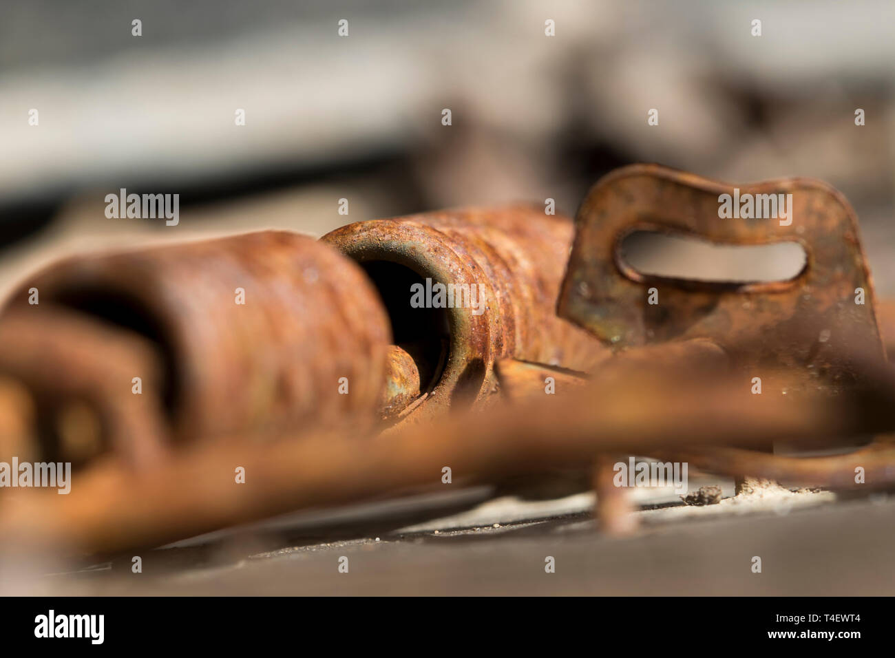 Old rat trap hing and steel spring system. Close up texture of rust and ...