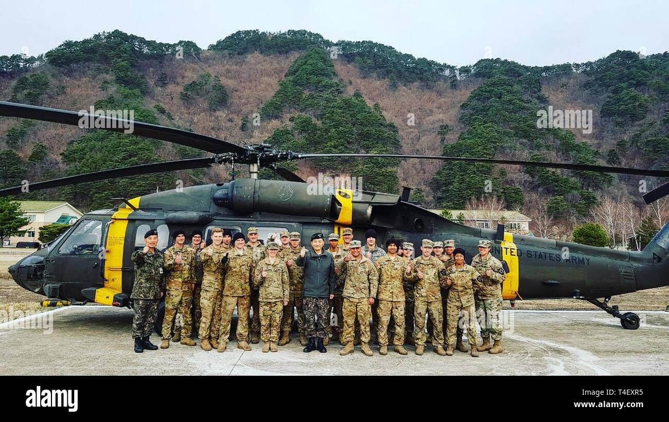 GANGWON, Republic of Korea — Soldiers with 2-2 Assault Helicopter Battalion and 3-2 General Support Aviation Battalion, 2nd Combat Aviation Brigade, 2nd Infantry Division/ROK-U.S. Combined Division and ROK army leadership display their unity after fighting the wildfire in Gangwon province, northeast of Seoul, April 6. The ROK-U.S. Alliance is an enduring relationship that continues to grow through shared experiences. Stock Photo