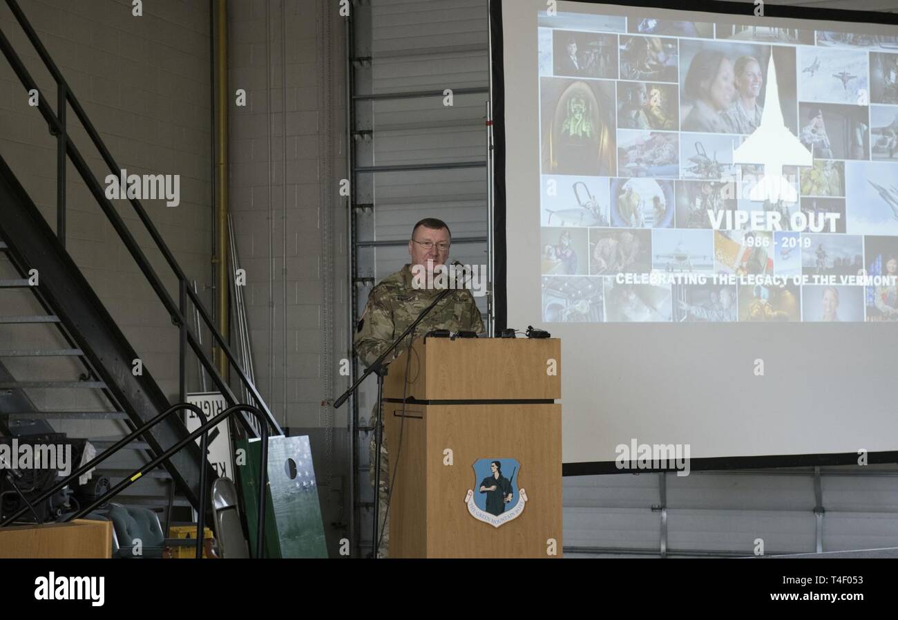 U.S. Army Brig. Gen. Gregory Knight, adjutant general of the Vermont National Guard, speaks to a crowd of nearly 2,000 Airmen, retirees, their family members, and the media at the 'Viper Out' ceremony at the Vermont Air National Guard Base, South Burlington, Vt., April 6, 2019. The F-16s are leaving the VTANG after 33 years of service ahead of F-35 Lightning IIs arriving later in 2019. Stock Photo