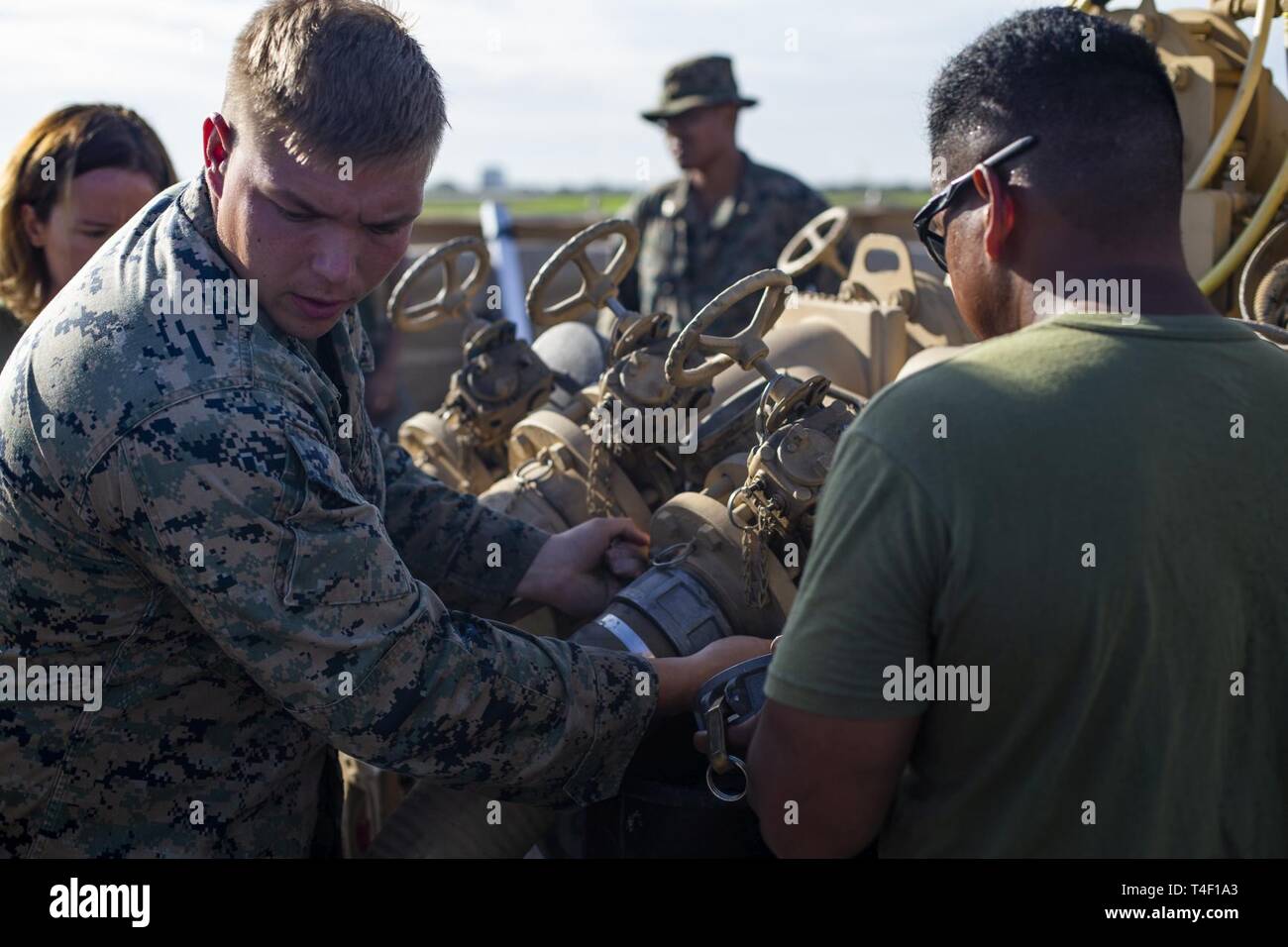 U.S. Marine Corps Cpl. Michael Northcraft removes a hose from an