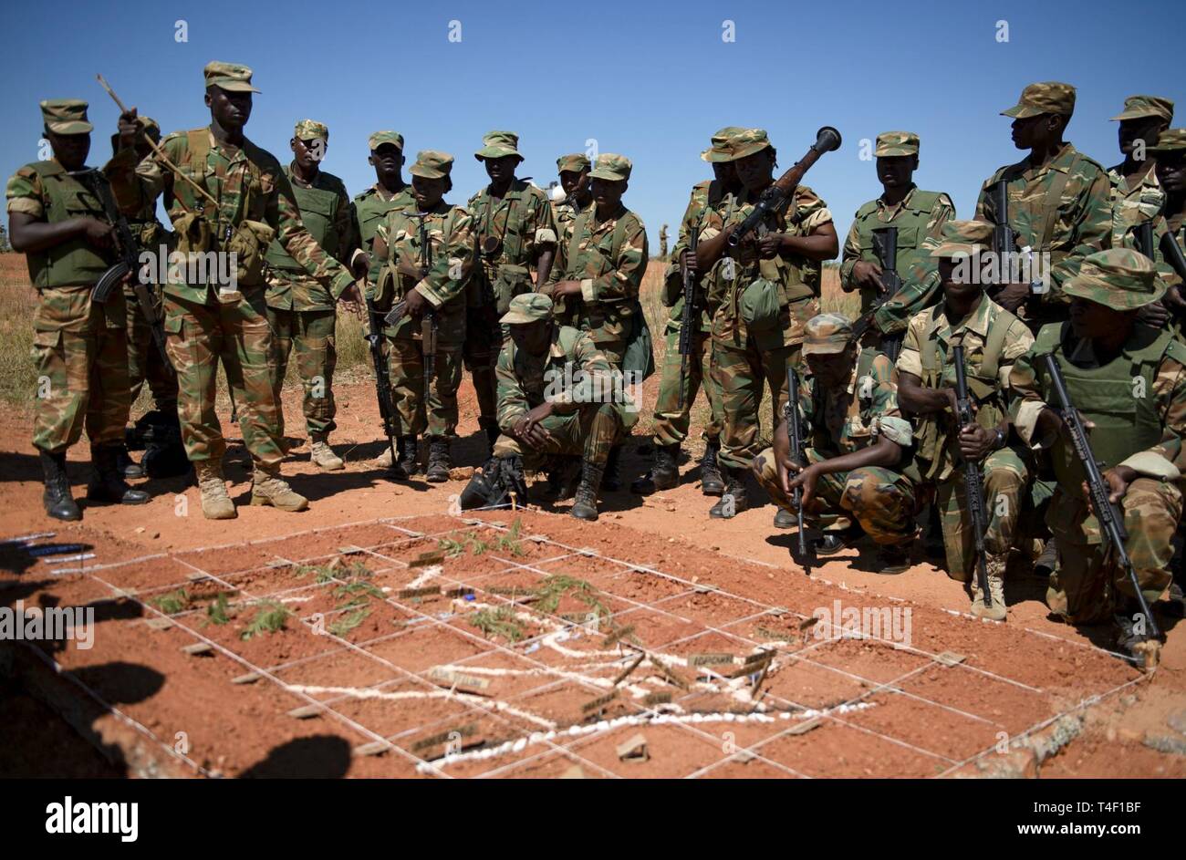 Zambian soldiers go over a premission brief before heading out on