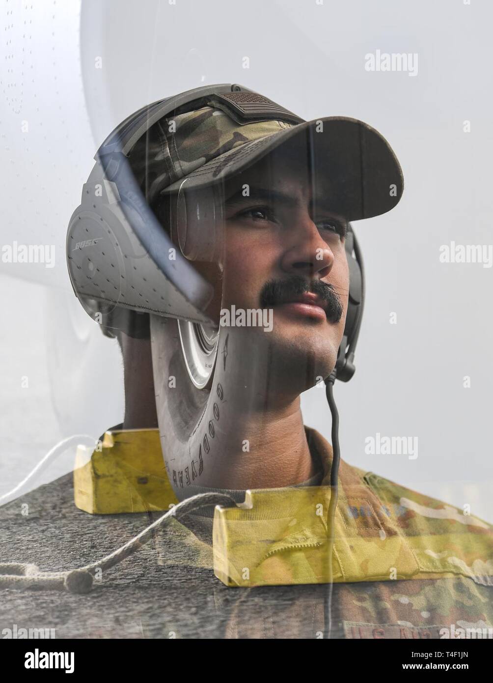 U.S. Air Force Senior Airman Brian Goodes, an aircraft maintainer assigned to the 75th Expeditionary Airlift Squadron, Combined Joint Task Force-Horn of Africa (CJTF-HOA), stands for an in-camera double exposure portrait at Maputo International Airport, Mozambique, April 7, 2019, for the U.S. Department of Defense’s relief effort in the Republic of Mozambique and surrounding areas following Cyclone Idai. Teams from CJTF-HOA, which is leading DoD support to relief efforts in Mozambique, began immediate preparation to respond following a call for assistance from the U.S. Agency for International Stock Photo