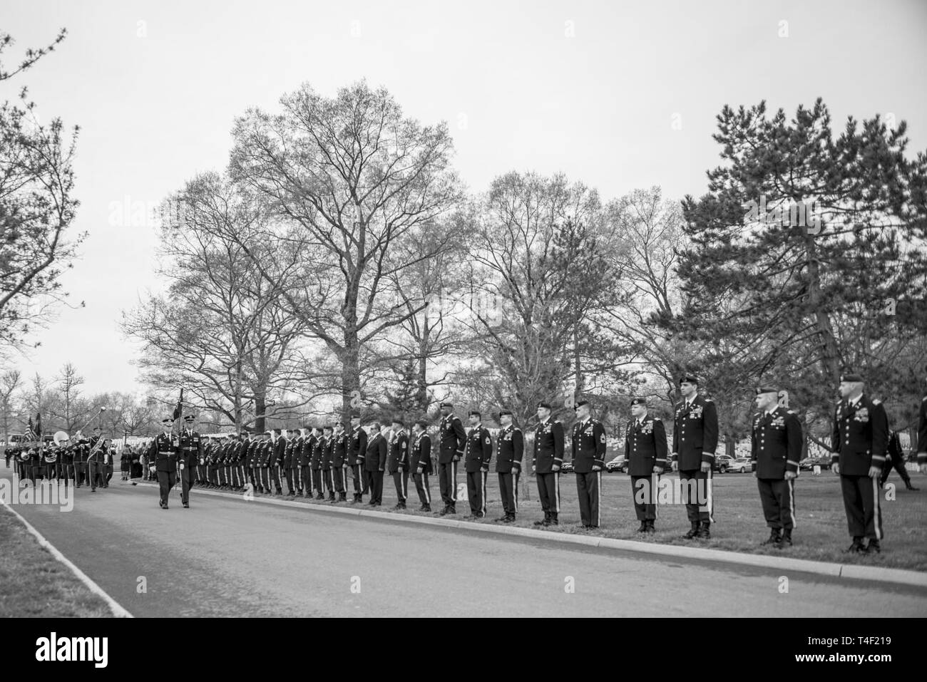 Soldiers from the 3d U.S. Infantry Regiment (The Old Guard); The U.S. Army Band, “Pershing’s Own”, and The 3d U.S. Infantry Regiment (The Old Guard) Caisson Platoon, conduct military funeral honors with funeral escort for U.S. Army Chief Warrant Officer 2 Jonathan Farmer in Section 60 of Arlington National Cemetery, Arlington, Virginia, April 9, 2019.    Farmer joined the Army on March 30, 2005 and graduated in 2007 from One Station Unit Training at Fort Benning, Georgia to become a Special Forces engineer sergeant. He earned his commission as a Special Forces warrant officer in 2016 and after Stock Photo