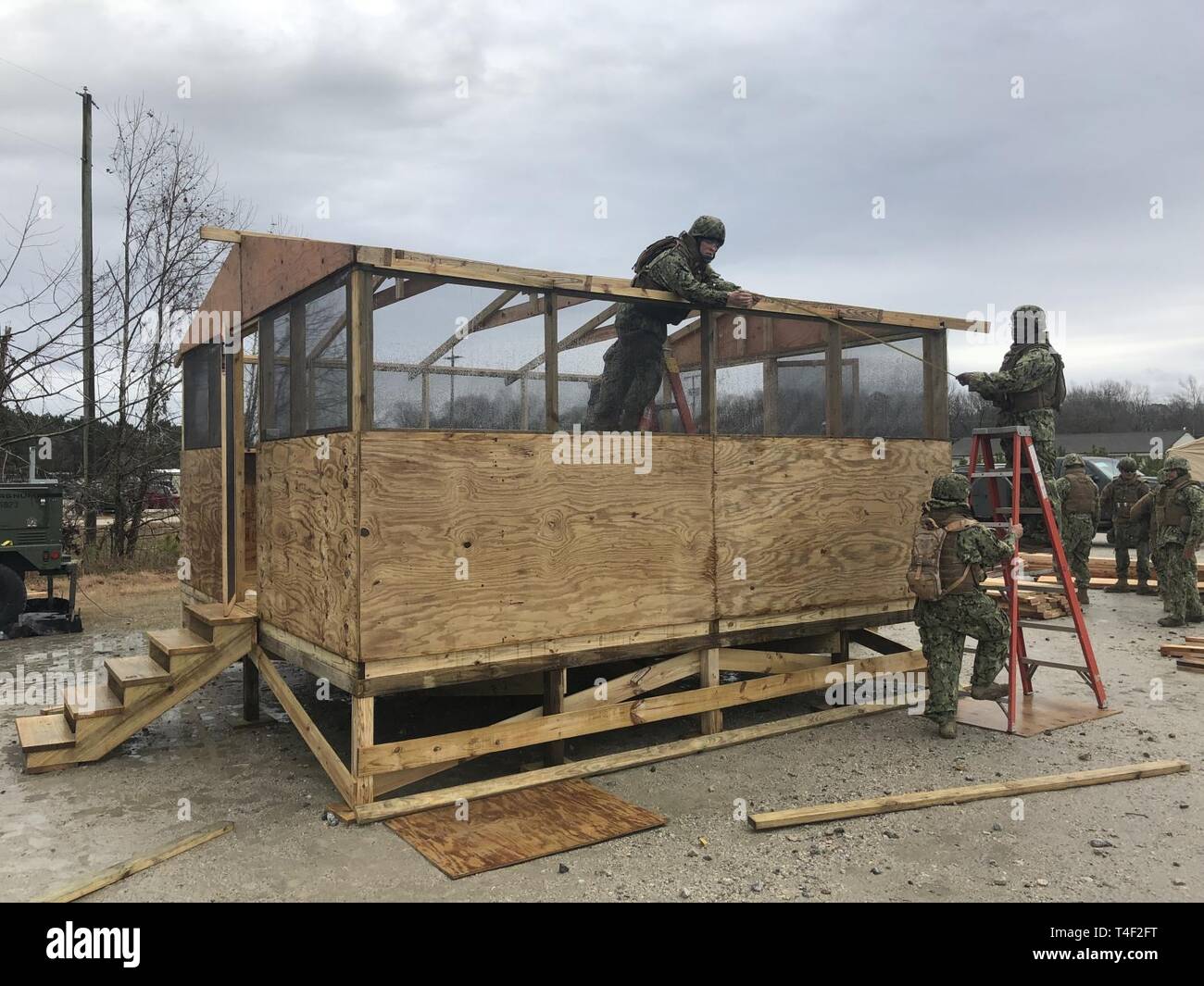 CHEATHAM ANNEX, Va. (Mar. 21, 2019) - Seabees from Construction Battalion Maintenance Unit (CBMU) 202 construct a Southeast Asia Hut during a field training exercise at Cheatham Annex Naval Weapons Station Yorktown. CBMU-202 provides contingency public works support for advanced bases and expeditionary medical facilities, expeditionary support for Naval Construction Force higher headquarters, line haul and equipment maintenance, general engineering, construction support, and humanitarian assistance and disaster recovery to Navy regional commanders. Stock Photo