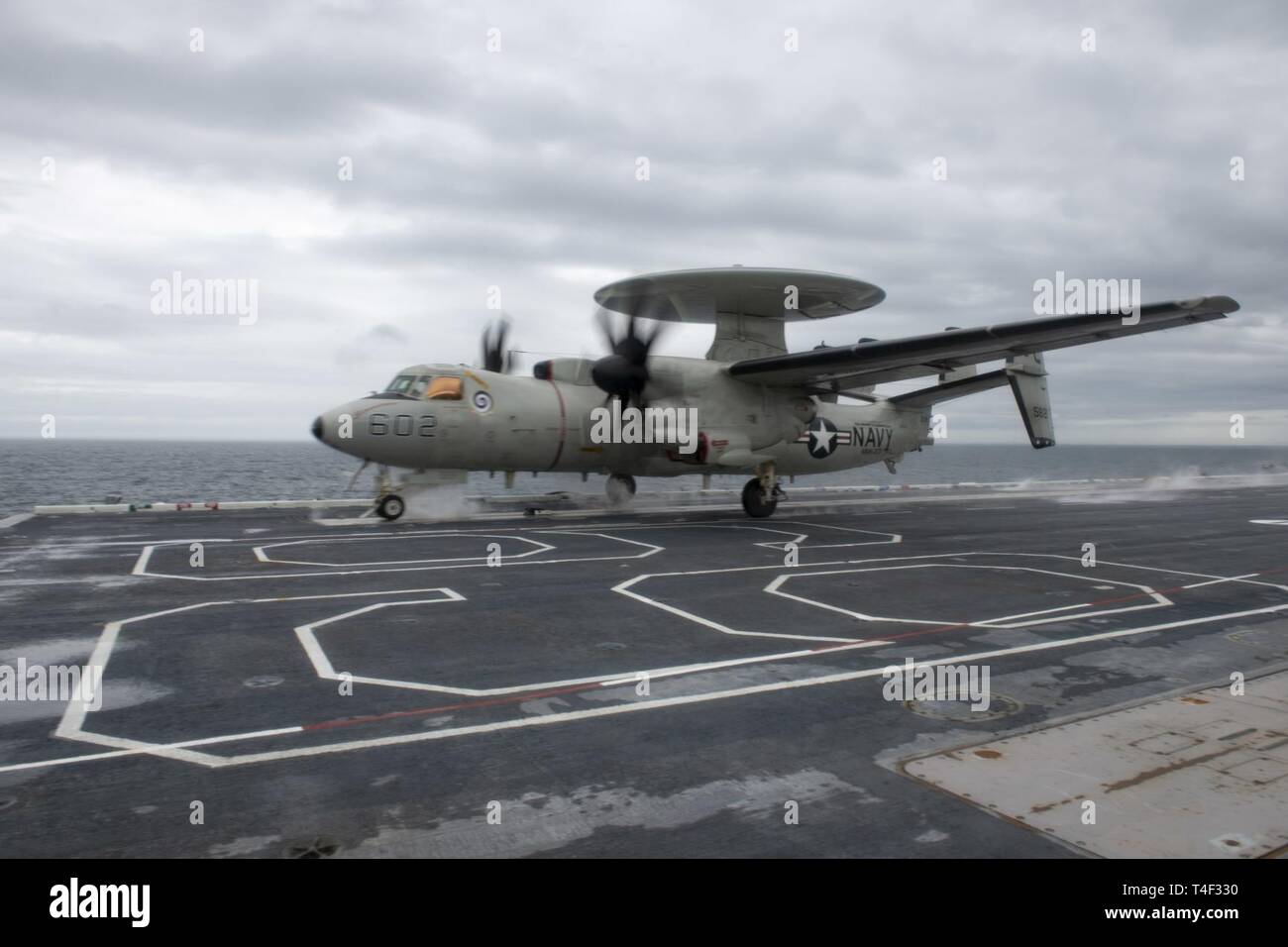 OCEAN (April 9, 2019) An E-2CC Hawkeye early warning and attack aircraft, assigned to the 'Screwtops' of Airborne Early Warning Squadron (VAW) 123 takes off on the flight deck of the aircraft carrier USS Dwight D. Eisenhower (CVN 69). Ike is underway conducting flight deck certification during the basic phase of the Optimized Fleet Response Plan (OFRP). Stock Photo