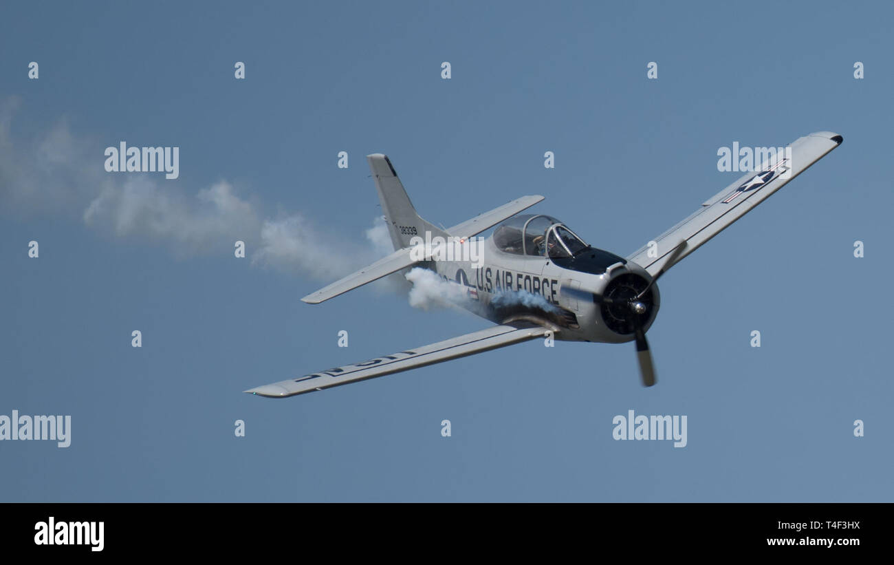 A pilot for the Trojan Thunder T-28 aerial demonstration team performs over the Ohio River during the annual Thunder Over Louisville airshow in Louisville, Ky., April 13, 2019. Hundreds of thousands of spectators turned out to view the event, which has grown to become one of the largest single-day air shows in North America. (U.S. Air National Guard photo by Dale Greer) Stock Photo