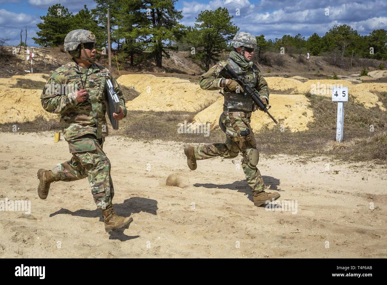 U.S Army Staff Sgt. Johnny Soriano, left, evaluates Spc. Daniel P