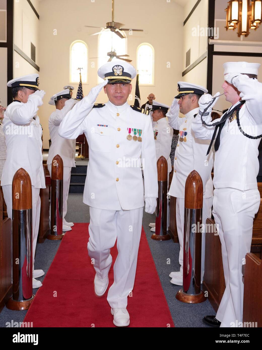 Lt. Cmdr. Felix Villanueva, assigned to Navy Medicine West, goes ashore for the last time at the conclusion of his retirement ceremony at the Chapel aboard Navy Station San Diego. Lt. Cmdr. Villanueva concluded a 28 year career on 11 April 2019 in a small ceremony surround by his family, friends, and closest colleagues. Stock Photo