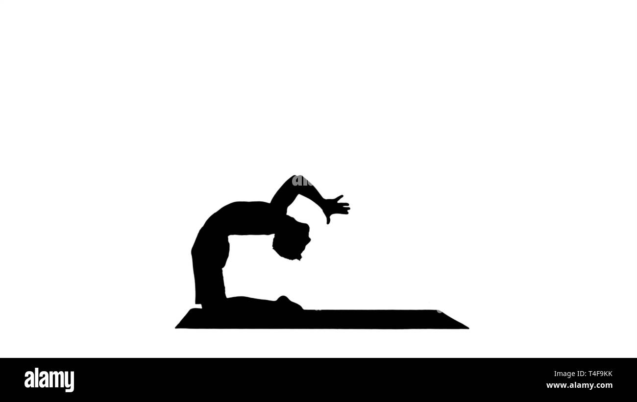 Silhouette Yogi doing camel yoga pose. Stock Photo