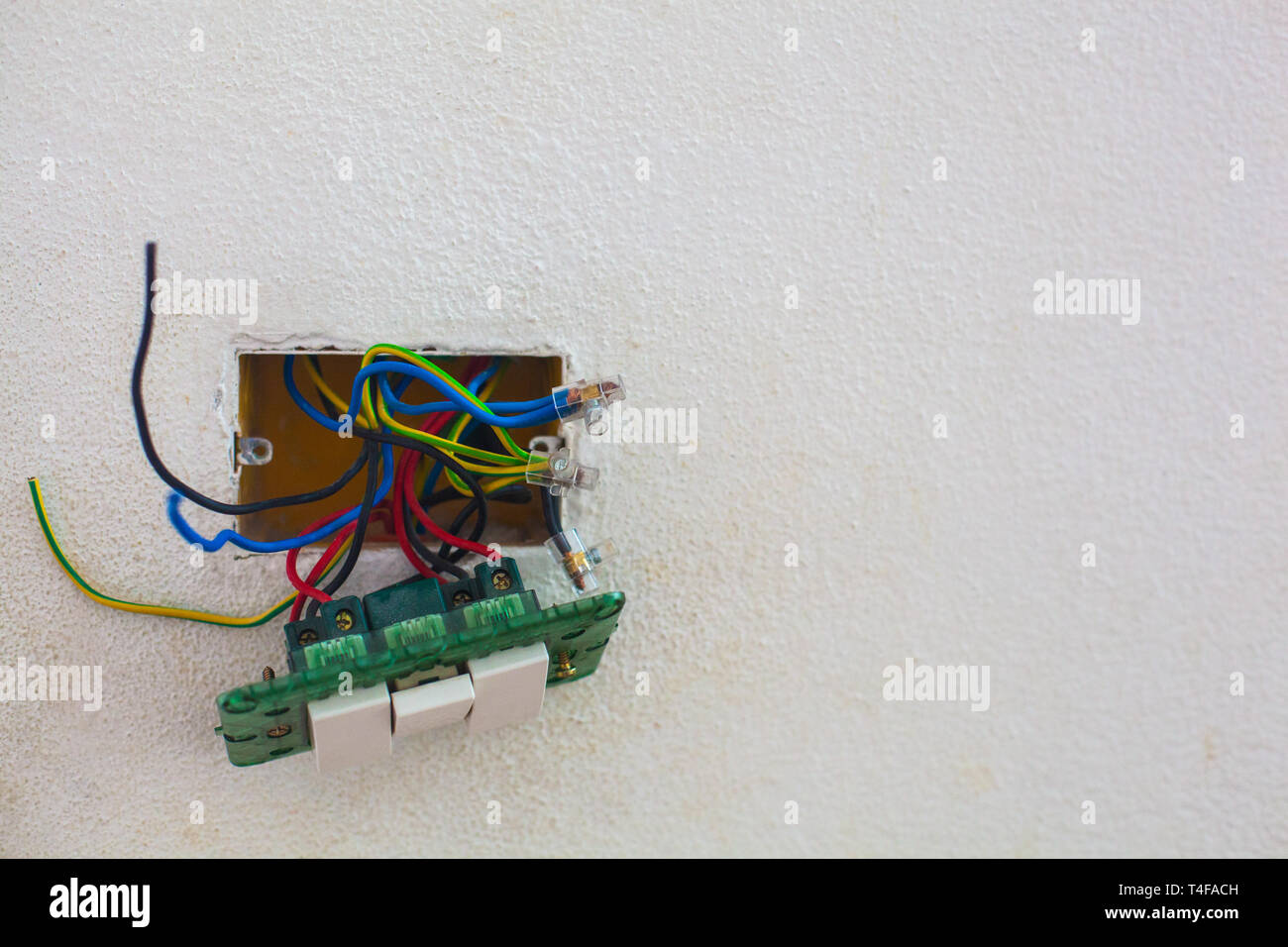 Open light switch with wires sticking out Stock Photo