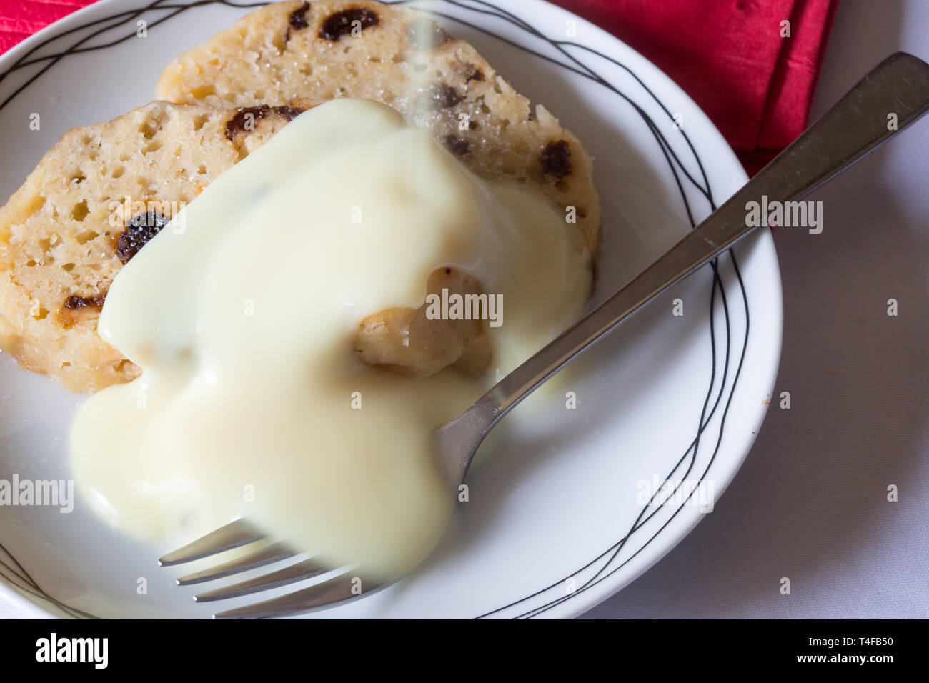Traditional classic English pudding of Spotted dick with custard sauce Stock Photo