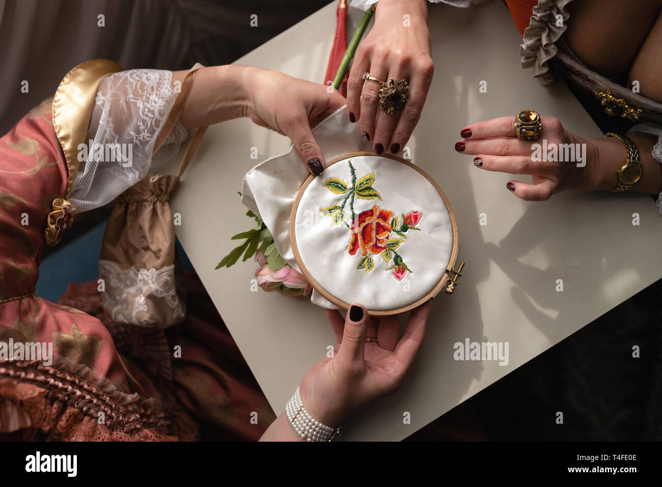 Retro style royal medieval ball - Majestic palace with gorgeous people dressed in king and queen's friends dresses with accessories such as fan and Stock Photo