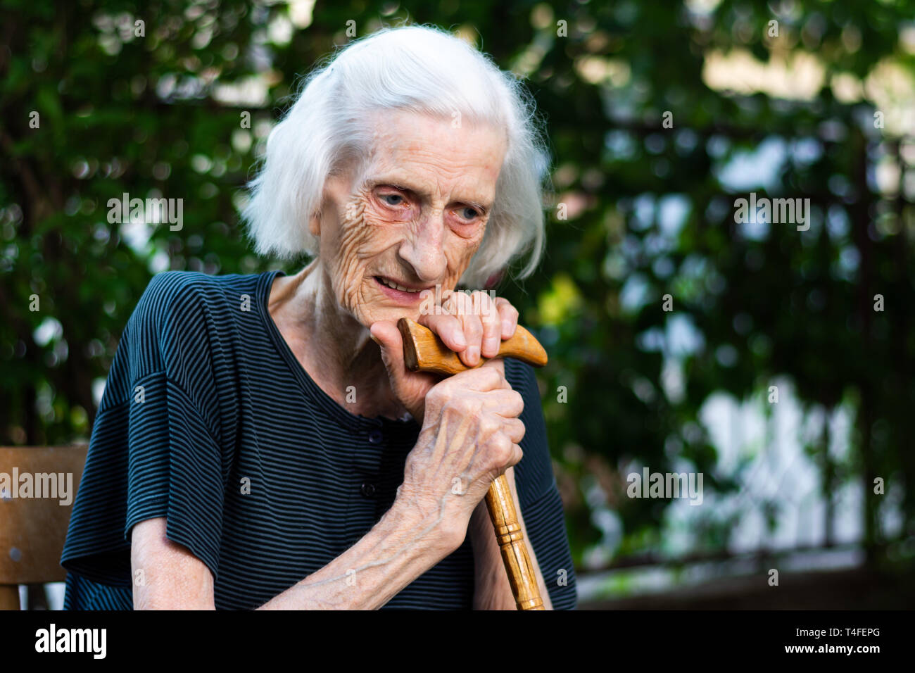 Portrait of a senior woman with a walking cane outdoors Stock Photo
