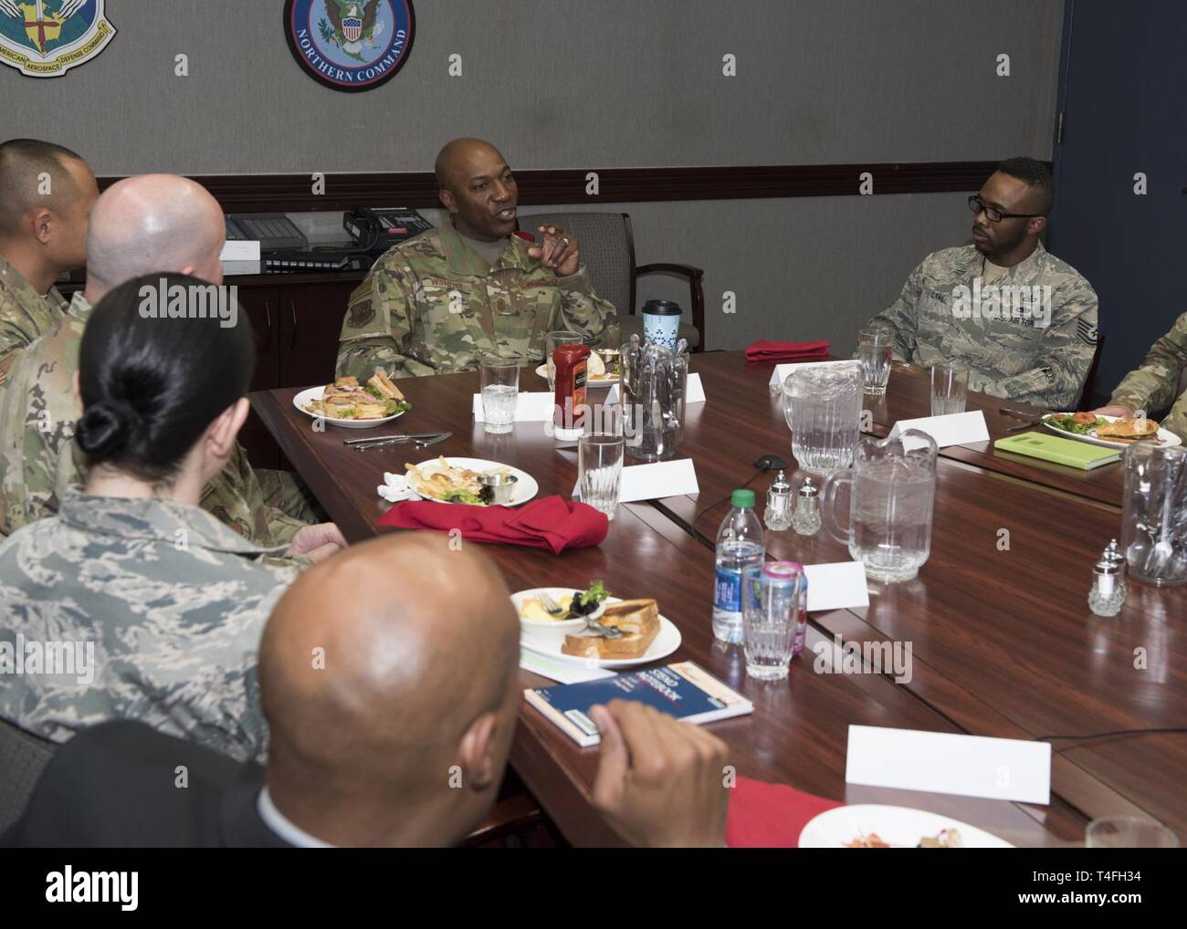 Chief Master Sergeant of the Air Force, Kaleth O. Wright speaks with Junior Enlisted and Non-Commissioned Officers during an informal lunch at the North American Aerospace Defense Command and U.S. Northern Command headquarters in Colorado Springs, Colorado, April 10, 2019. Chief Wright spent the afternoon meeting Airmen assigned to the world's only joint and bi-national command responsible for protecting and defending the homeland. Stock Photo