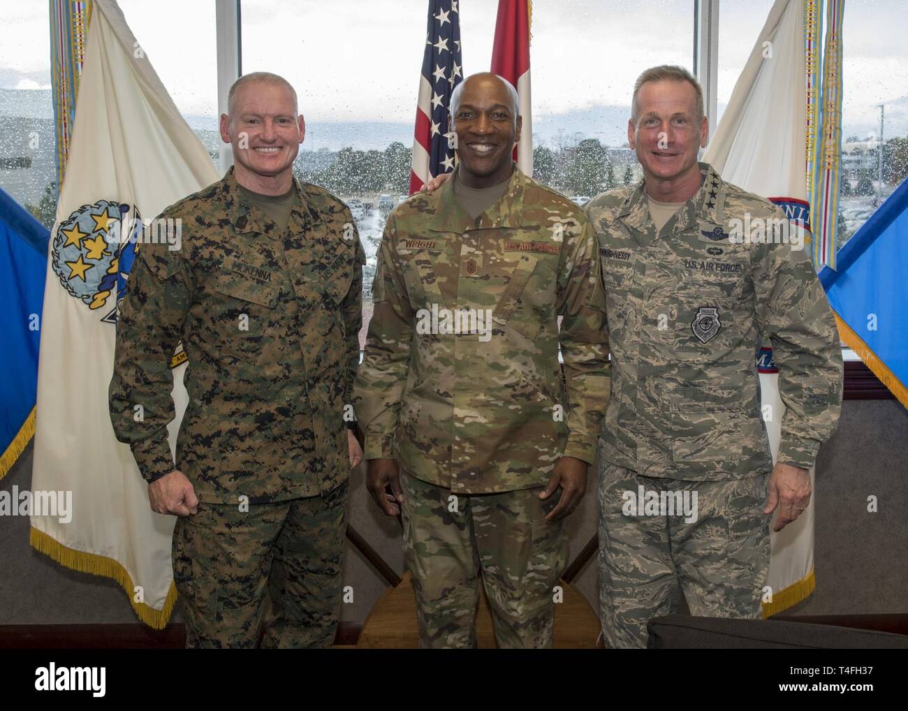 Chief Master Sergeant of the Air Force, Kaleth O. Wright (center), U.S. Air Force Gen. Terrence J. O’Shaughnessy, Commander, North American Aerospace Defense Command and U.S. Northern Command (left), and Marine Corps Command Sergeant Major Paul McKenna, the NORAD and USNORTHCOM Command Senior Enlisted Leader, pose for a photo in the command’s headquarters building in Colorado Springs, Colorado, April 10, 2019. Chief Wright spent the afternoon meeting Airmen assigned to the world's only joint and bi-national command responsible for protecting and defending the homeland. Stock Photo