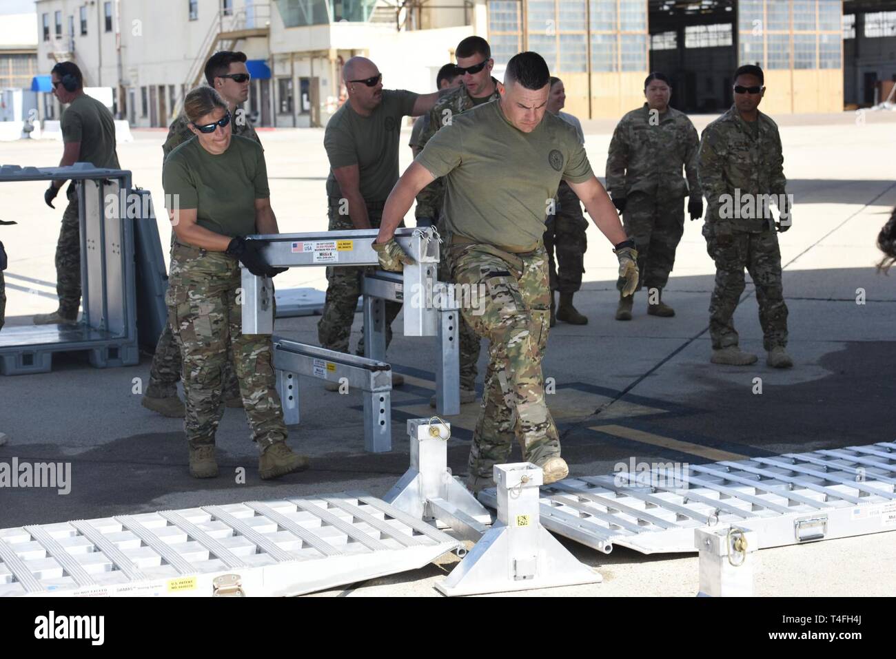 Crewmembers from the Coast Guard Maritime Security and Response Team – West, San Diego, load equipment for a training mission onto an Alaska Air National Guard C-17 Globemaster April 2, 2019 at Naval Air Station North Island, Coronado, California. The MSRT-W members are scheduled to take part in a multi-agency readiness exercise upon their arrival in Alaska. Stock Photo