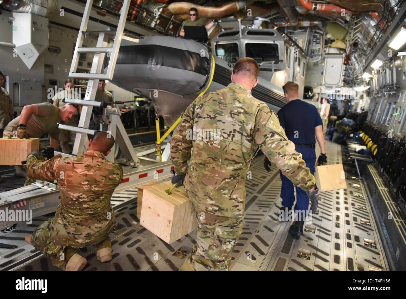 Crewmembers from the Coast Guard Maritime Security and Response Team – West, San Diego, load equipment for a training mission onto an Alaska Air National Guard C-17 Globemaster April 2, 2019 at Naval Air Station North Island, Coronado, California. The MSRT-W members are scheduled to take part in a multi-agency readiness exercise upon their arrival in Alaska. Stock Photo