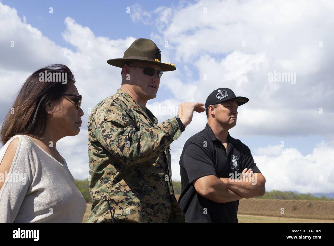 U.S. Marine Corps Chief Warrant Officer 2 Jeffrey Wright, center, officer in charge of Pu’uloa Range Training Facility, leads a tour of the grounds for Rep. Rida Arakawa, left, of Hawaii's Ewa District and Mitchell Tynanes, right, Ewa Neighborhood Board Chair, Marine Corps Base Hawaii (MCBH), Apr. 8, 2019. During the visit, MCBH leadership discussed and showcased Marine Corps marksmanship training, community partnerships, and the positive economic impact from MCBH facilities and service members. Stock Photo