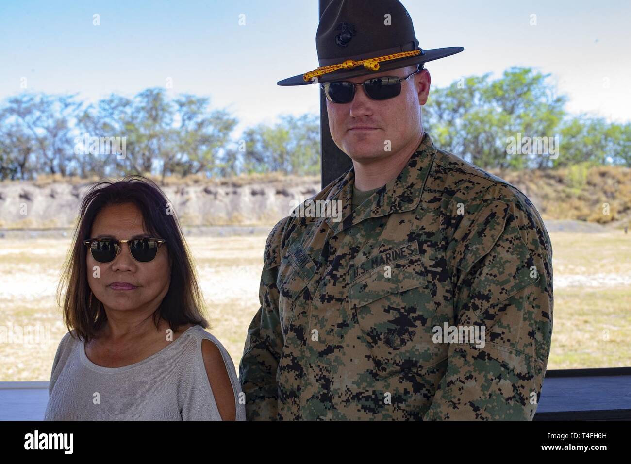 U.S. Marine Corps Chief Warrant Officer 2 Jeffrey Wright, right, officer in charge of Pu’uloa Range Training Facility, takes a photo with Rep. Rida Arakawa, left, of Hawaii's Ewa District, Marine Corps Base Hawaii (MCBH), Apr. 8, 2019. During the visit, MCBH leadership discussed and showcased Marine Corps marksmanship training, community partnerships, and the positive economic impact from MCBH facilities and service members. Stock Photo