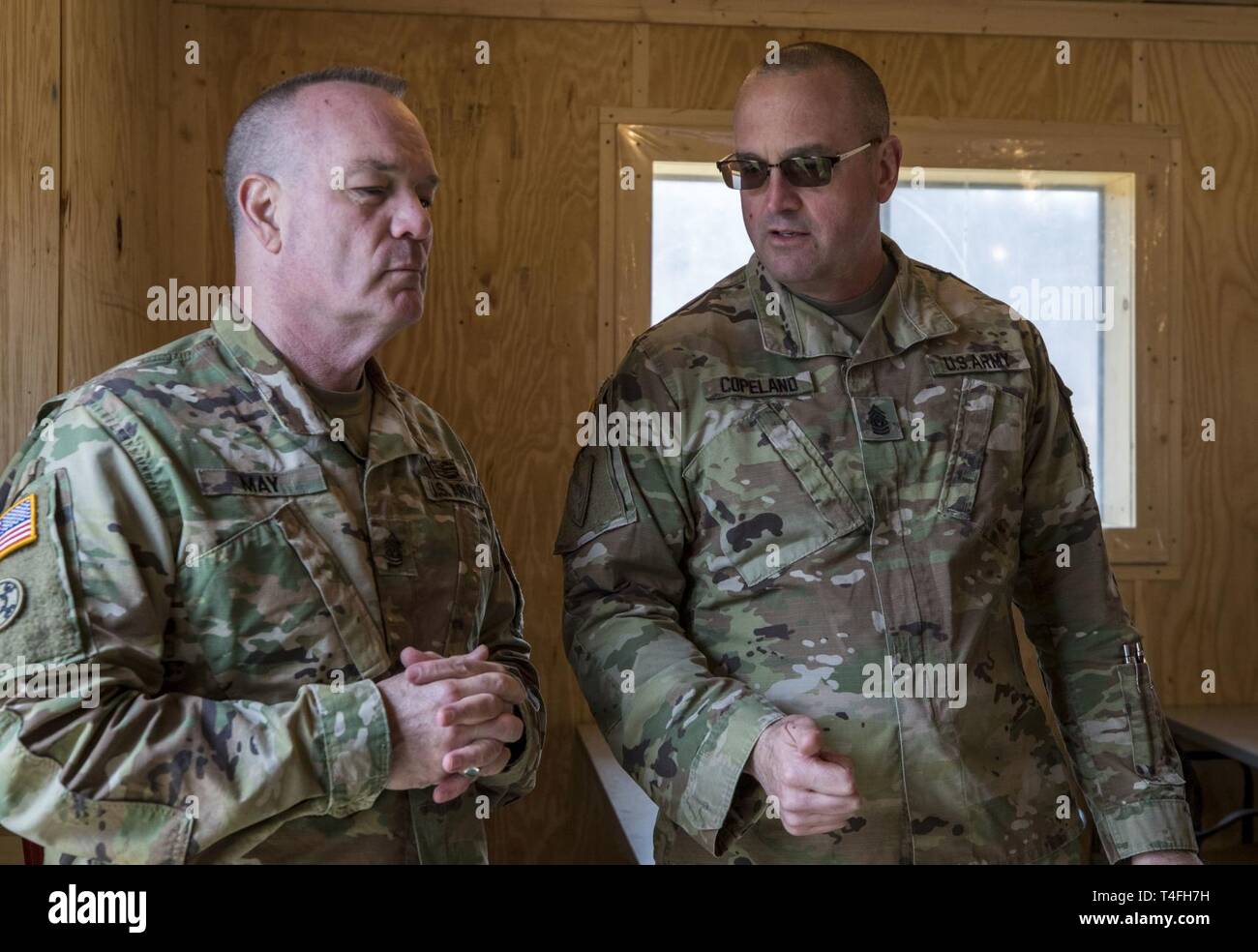 Command Sgt. Maj. Ted L. Copeland, the command sergeant major for the U.S.  Army Reserve talks with Command Sgt. Maj. Larry Lawrence, the command  sergeant major for the 84th Training Command, during