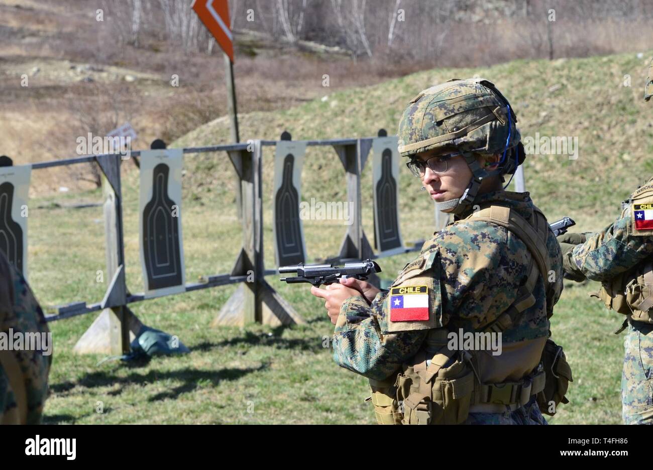 A Chilean cadet from the Bernardo O'Higgins Military School, Chile, takes part in an M9 pistol range in preparation for the 51st Sandhurst Military Skills Competition in West Point, New York, April 12-13. Sandhurst, a premier international military academy competition which began in 1967, is a two-day, approximately 30-mile course filled with individual and squad-based events designed to promote military excellence of future leaders across the world. This year, 49 teams from more than a dozen countries will participate in the competition, with two first-time teams competing from Denmark and Gr Stock Photo