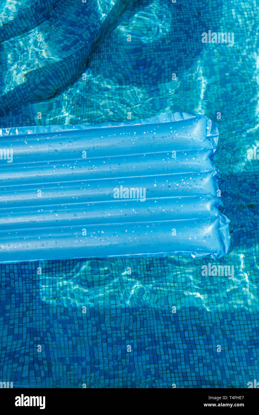 Inflatable water activities mattresses float on the water in the pool