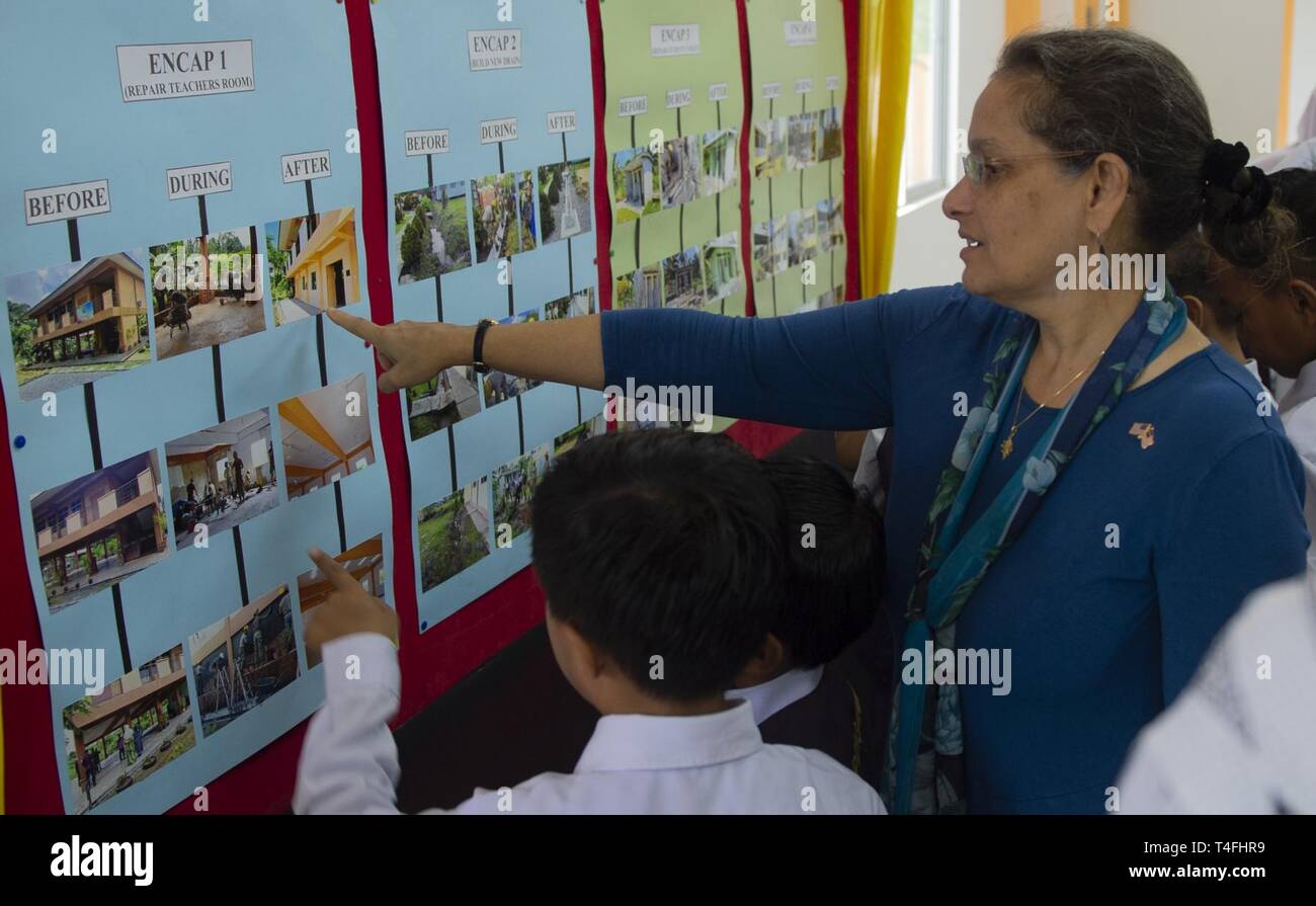 Malaysia (April 11, 2019) – U.S. Ambassador to Malaysia, Kamala Lakhdhir looks at the results of a construction project following the ribbon cutting ceremony at Sambir Elementary School. These engagements promote cooperation and friendship between Pacific Partnership 2019 participants and the host nation. Pacific Partnership, now in its 14th iteration, is the largest annual multinational humanitarian assistance and disaster relief preparedness mission conducted in the Indo-Pacific. Each year the mission team works collectively with host and partner nations to enhance regional interoperability  Stock Photo