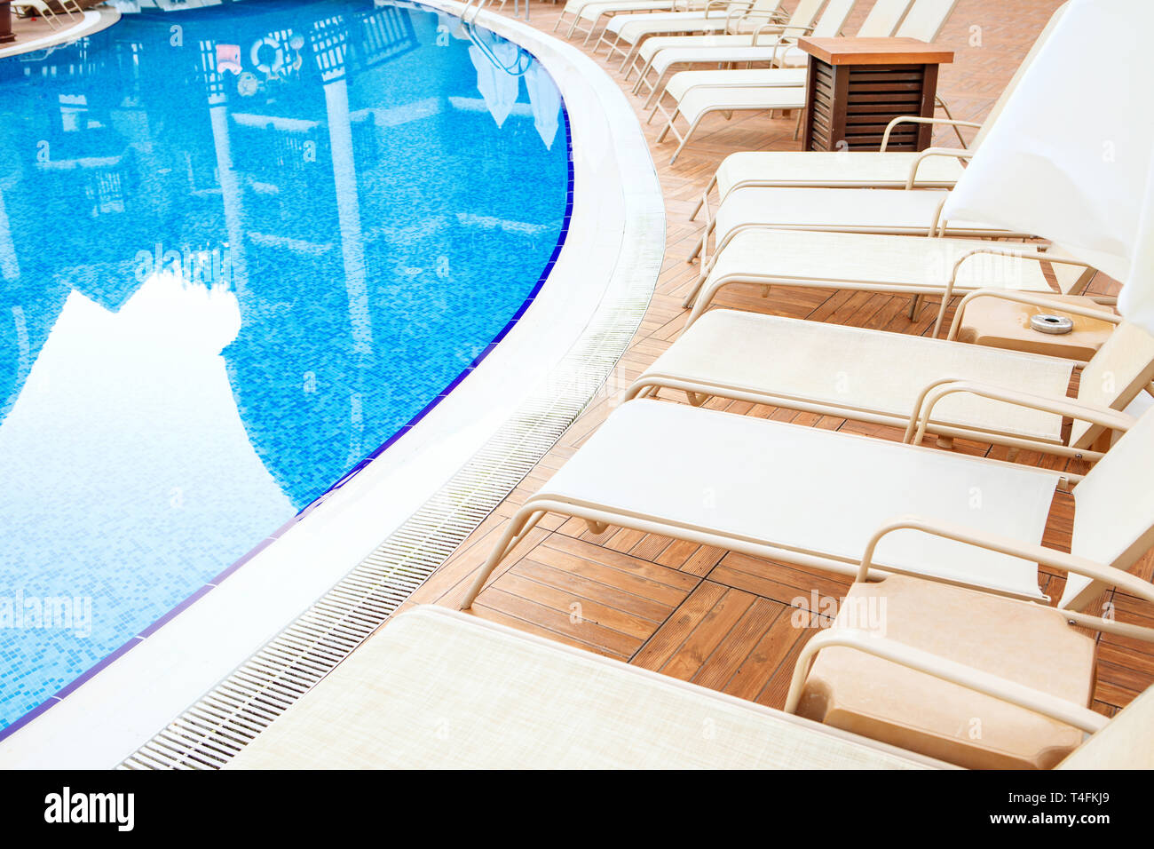 Swimming pool and lounges near hotel. Stock Photo