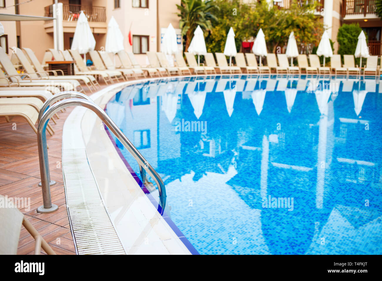 Swimming pool and lounges near hotel. Stock Photo