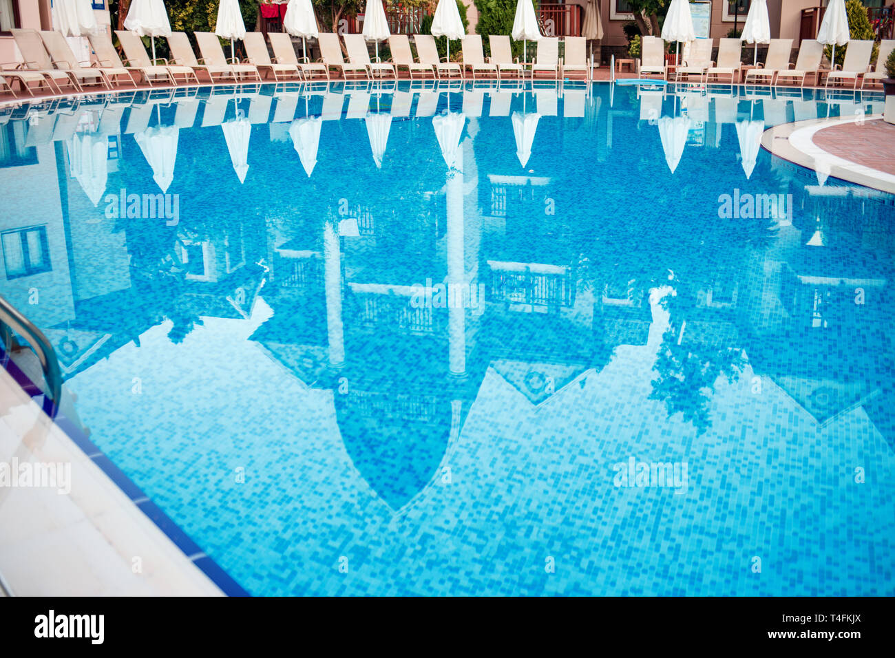 Swimming pool and lounges near hotel. Stock Photo