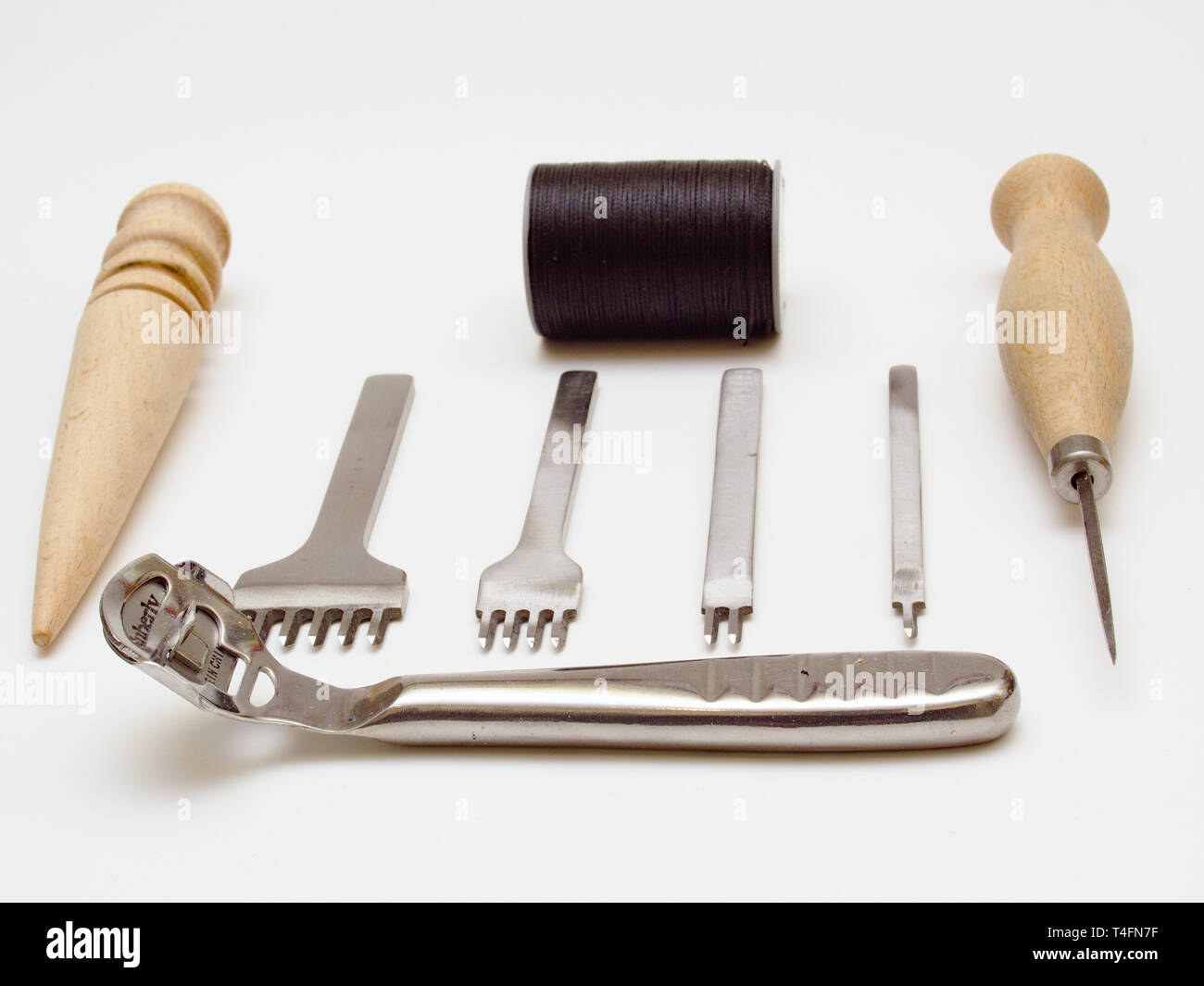 Leather working tools isolated on white background. Stock Photo